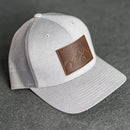 Leather Patch Performance Style Trucker Hat - Mountain Range Stamp