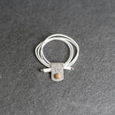 White cable with leather tag