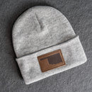 Gray beanie with a brown leather patch
