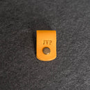 Yellow leather tag with 'JWP' 