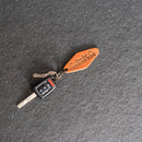 Keychain with a leather tag on a gray surface