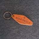 Brown leather keychain with 'WANDERLUST'