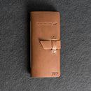 Brown leather hunting log book with a buckle