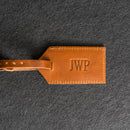 Brown leather tag with 'JWP'