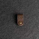 Brown leather strap with a gold button