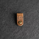 Brown leather strap with a gold button