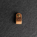 Small leather tag with a metal pin