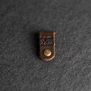 Small leather tag with a gold button